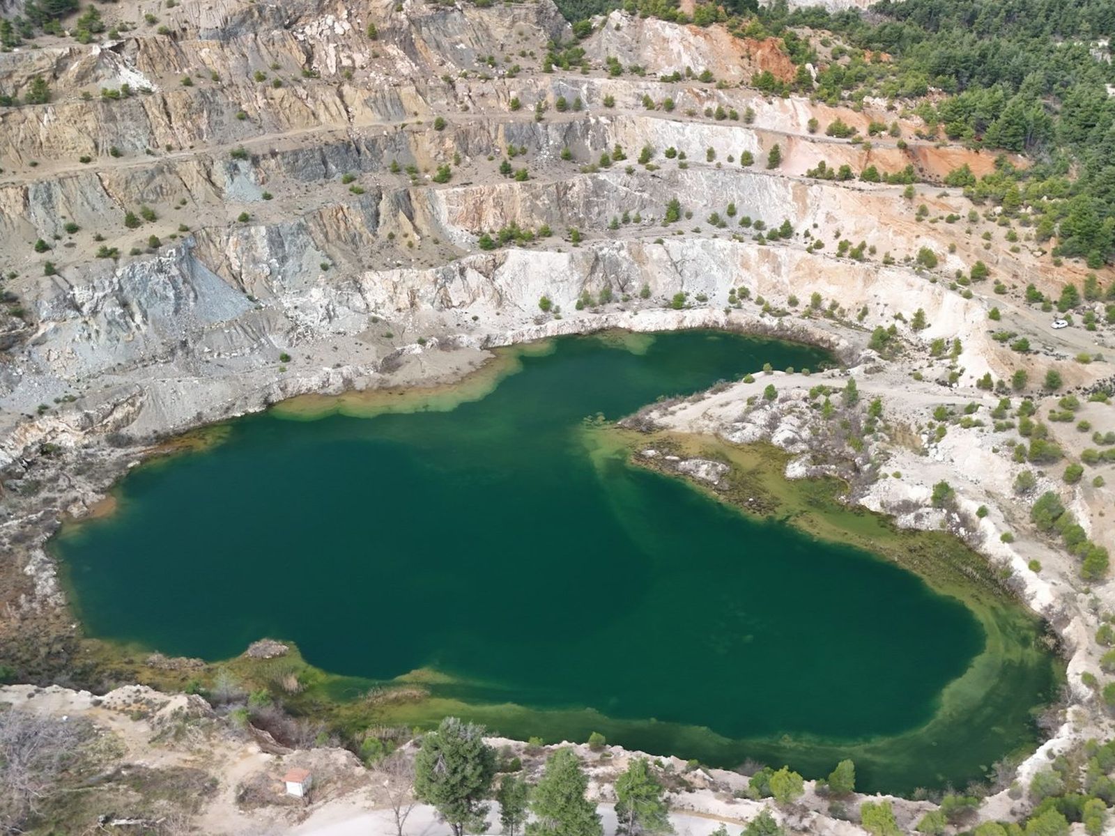 Quarry void part way through restoration, with backfilled areas and established grass